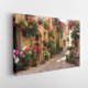 Tablou Canvas Medieval Alley with Flowers in Spello